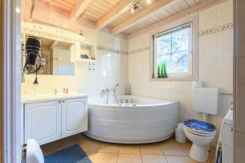 a bathroom with a tub and a sink and a toilet at Ferienhaus Seepferdchen in Baabe