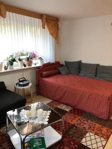 a living room with a bed and a couch at Ferienwohnung Edith in Güster