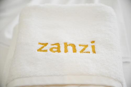 a white towel with the word zarma written on it at Hotel Zanzi in Durrës