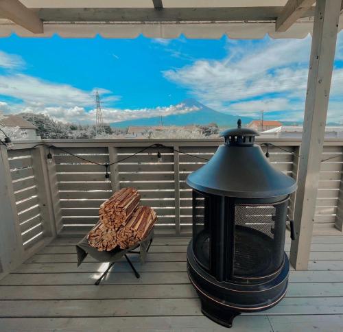 a black lantern sitting on a deck with a bench at Necoana Glamping Annovillasグランピング in Fujikawaguchiko