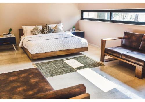 sypialnia z łóżkiem, kanapą i krzesłem w obiekcie Aspire villa 30 w mieście Lonavla