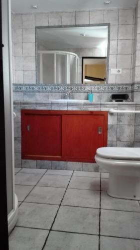 a bathroom with a sink and a toilet and a mirror at Sierra Alcaide in Zagrilla