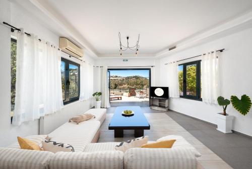 a living room with a couch and a table at Coastal Dream beachView Jacuzzi& sauna free parking WiFi 2 bedroom in Amoudara Lasithiou