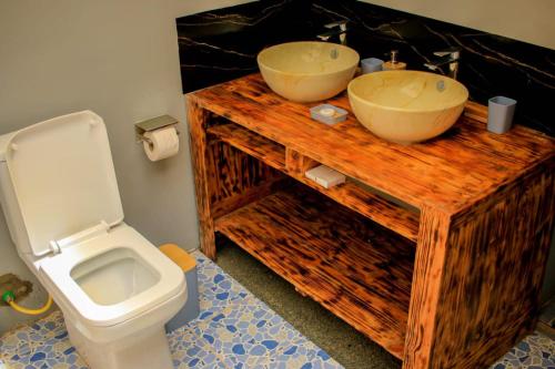 a bathroom with a sink and a toilet at Amanya Hut 3-Bedroom House Amboseli in Amboseli