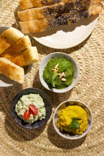 a table with four bowls of different types of dips at Soul Valley all-in boutique hotel with yoga & wellness in Maracalagonis