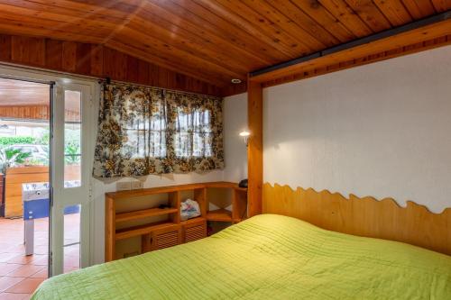 a bedroom with a green bed in a room at Loft in centro a Torre del Lago in Torre del Lago Puccini