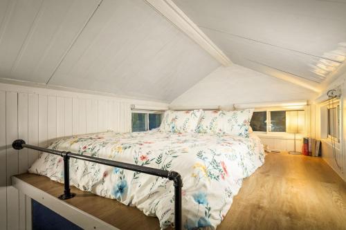 a bedroom with a bed in a attic at Quiet Lake House In Winery in Flowerdale