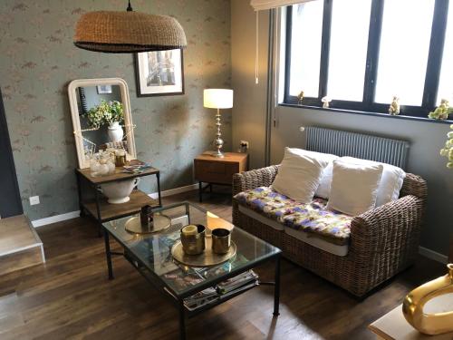 a living room with a couch and a table at Hotel Les Embruns in Le Touquet-Paris-Plage