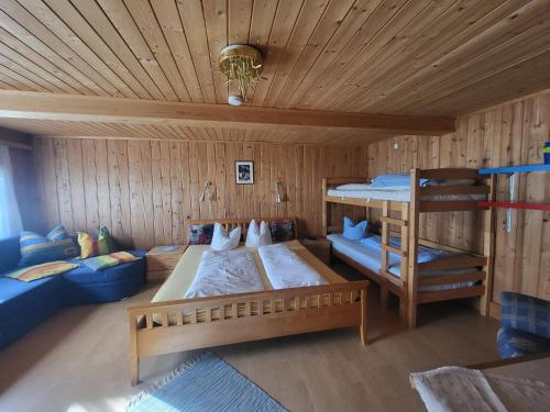 a bedroom with two beds and a bunk bed at Ferienhaus Unterbrunnhaus in Finkenberg