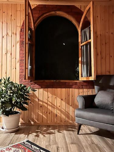 a living room with a couch and a window at Winery & Brewery - Family Guesthouse "Villa Rbona" in Khashuri