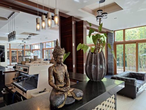 a statue sitting on a counter in a kitchen at Duna Garden Hotel in Budapest