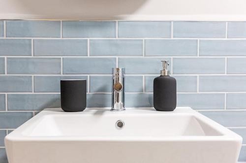 a white sink with two bottles on top of it at Chapel View in Loughborough