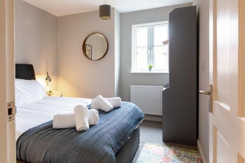 a bedroom with a bed with two pillows on it at Chapel View in Loughborough