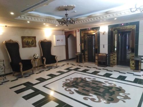 a lobby with chairs and a rug on the floor at أجنحة أبو قبع الفندقيةAbu Quboh Hotel Suite Apartment in Amman