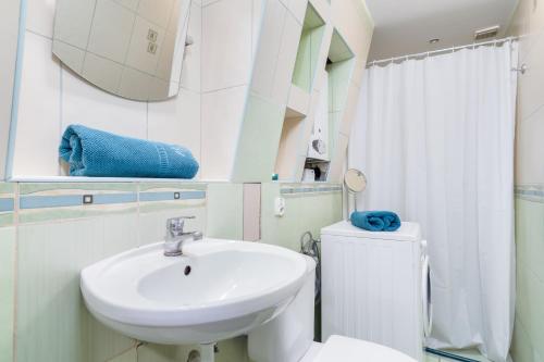 a bathroom with a sink and a toilet and a mirror at CozyApartment in Centre of Gdańsk! in Gdańsk