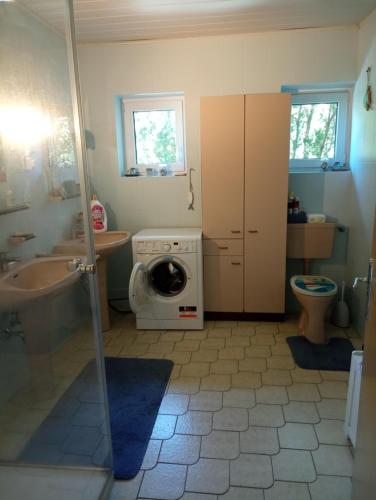 a bathroom with a washing machine and a washer at Urlaub am Glatzl Bauernhof in Sankt Lorenzen am Wechsel