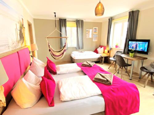 1 dormitorio con 2 camas y sala de estar en feels Beach Club Hotel en Kühlungsborn