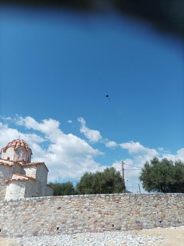 a building with a tower on top of a roof at Villa Fraoulitsa in Skoutarion