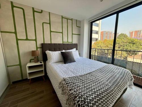 a bedroom with a bed and a large window at Cozy apartment near Airport in Guatemala