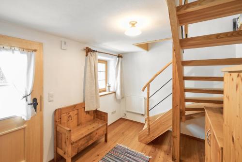 a room with a wooden staircase and a window at Beim Sattler in Peiting