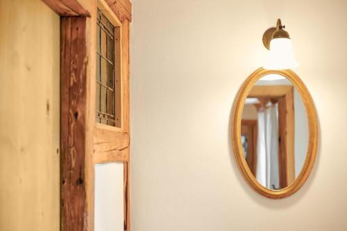 a mirror hanging on a wall next to a door at Beim Sattler in Peiting