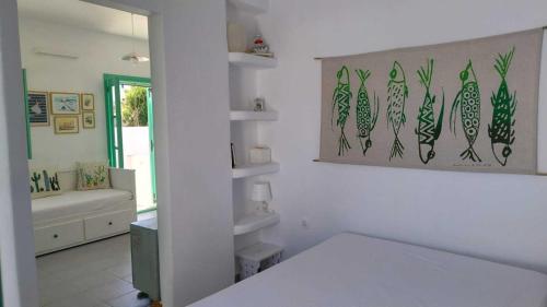 a white room with a bed and a bathroom at Ethel apartment in Alinda