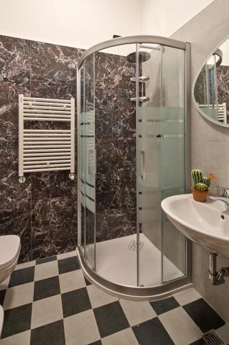 a bathroom with a glass shower and a sink at UNAHOTELS Ala Venezia-Adults 16 in Venice