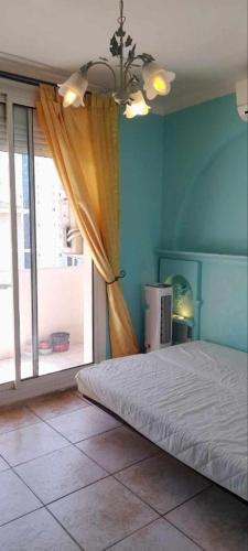 - une chambre avec un lit et une grande fenêtre dans l'établissement Chambre privée et climatisée dans un appartement de 4 chambres, à Toulon