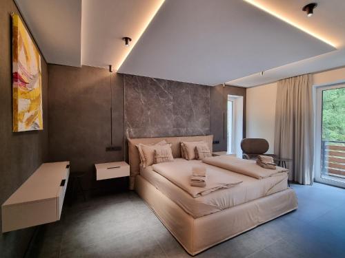 a bedroom with a large bed and a couch at DAS ERZ Medical Spa & Hotel in Crottendorf