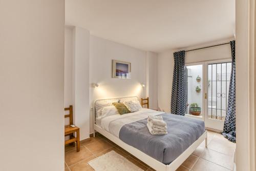 a bedroom with a bed and a window at Calella Pallafrugell in Palafrugell