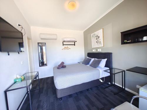 Ένα ή περισσότερα κρεβάτια σε δωμάτιο στο Altair Motel