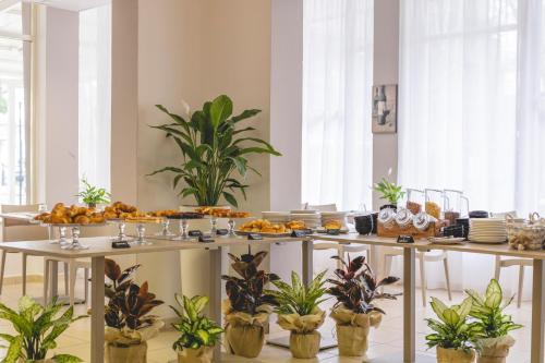a table with a bunch of food on it at Hotel La Perla in Cervia
