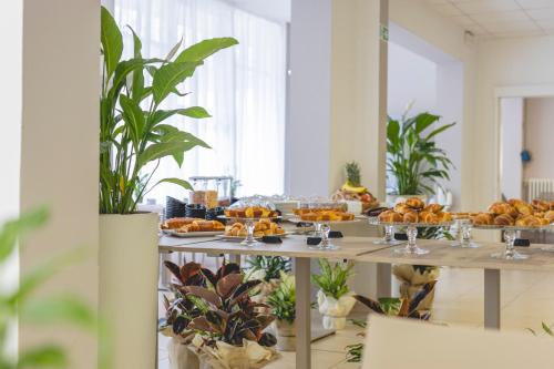 a buffet of food on a table in a room at Hotel La Perla in Cervia