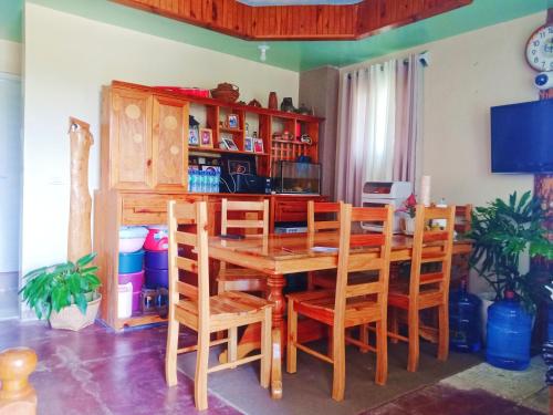 a dining room with a wooden table and chairs at Couple's Unit at BOONE'S in Sagada