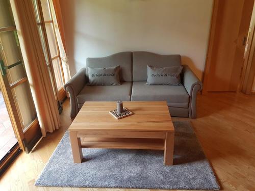 a living room with a couch and a coffee table at Zum Eichhof in Reit im Winkl