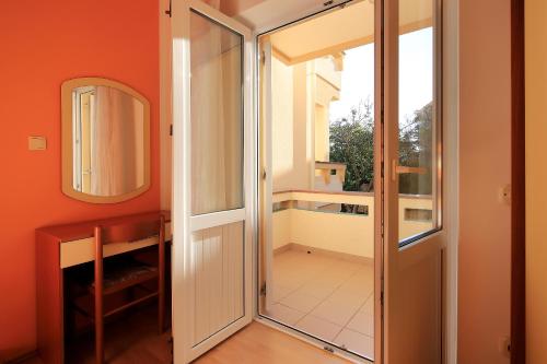 a door leading into a room with a balcony at Resort Trcol in Novalja