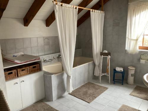 a bathroom with a bath tub and a sink at Escale sur la Côte in Porrentruy