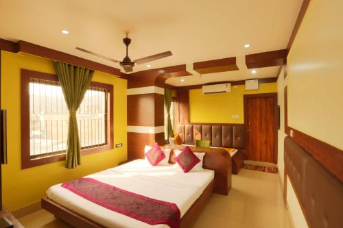 a bedroom with two beds and a window at Hotel Dream City in Guwahati