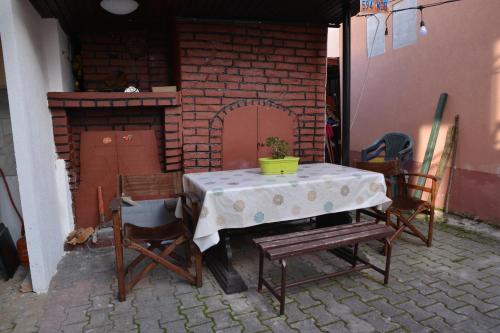 a table and chairs in front of a brick oven at Apartments Darija in Peštani