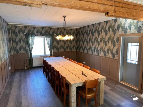 a conference room with a wooden table and chairs at Enonkosken Kartano & Guesthouse in Enonkoski