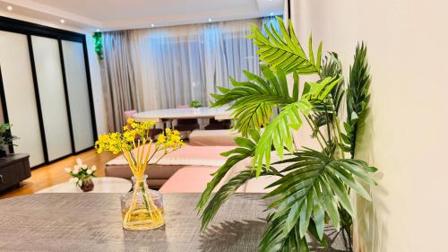 two vases sitting on a table with plants at Sweet home near Paris with Eiffel Tower view & 1 cozy private room or entire apartment with 3 rooms in Courbevoie