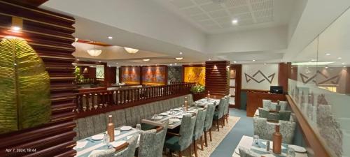 a restaurant with tables and chairs in a room at Coronet The Boutique Hotel in Pune