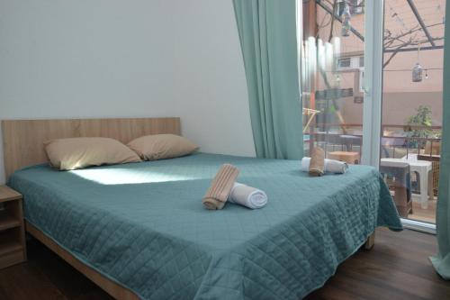 a bedroom with a bed with two pillows on it at Apartments Darija in Peštani