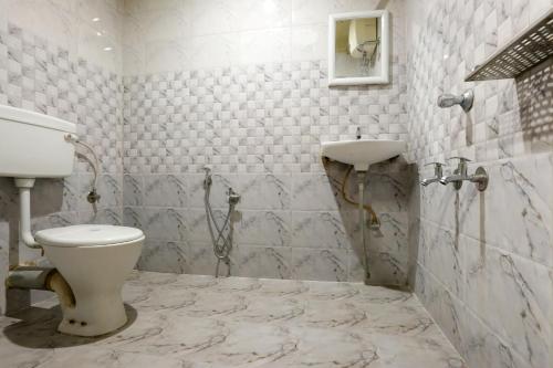 a bathroom with a toilet and a sink at Hotel Dream City in Guwahati