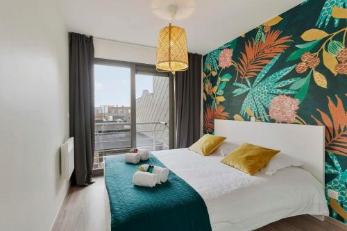 a bedroom with a bed with two stuffed animals on it at Cosy apartment with amazing beach view in Ostend