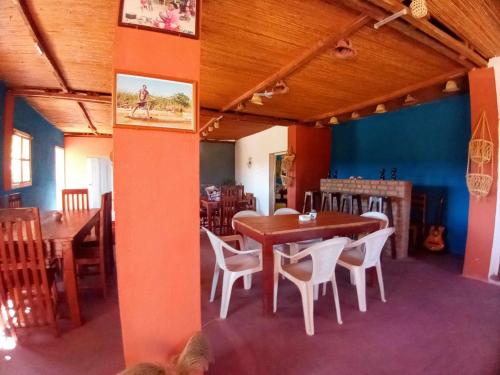 a dining room with a wooden table and chairs at Ecolodge d'Isalo in Ranohira