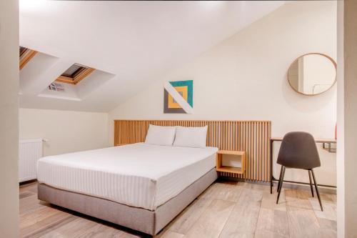 a bedroom with a white bed and a chair at Hotel Forty One in Bucharest
