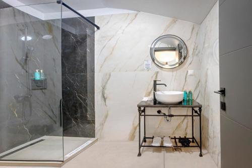 a bathroom with a shower and a sink and a mirror at Hotel Forty One in Bucharest