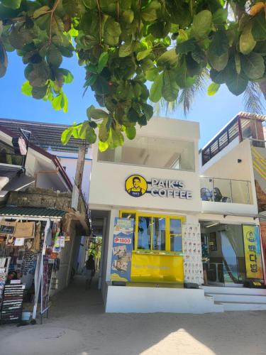 a building with a store with a yellow storefront at Sunvilla beachfront hotel in Boracay