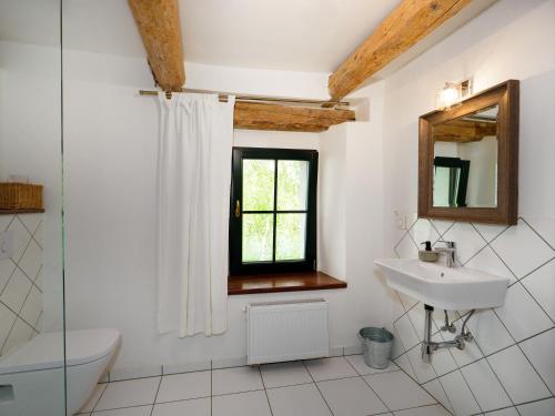 a white bathroom with a sink and a window at Płonica 1 in Złoty Stok